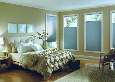 Master bedroom with wall of window covered in custom coverings